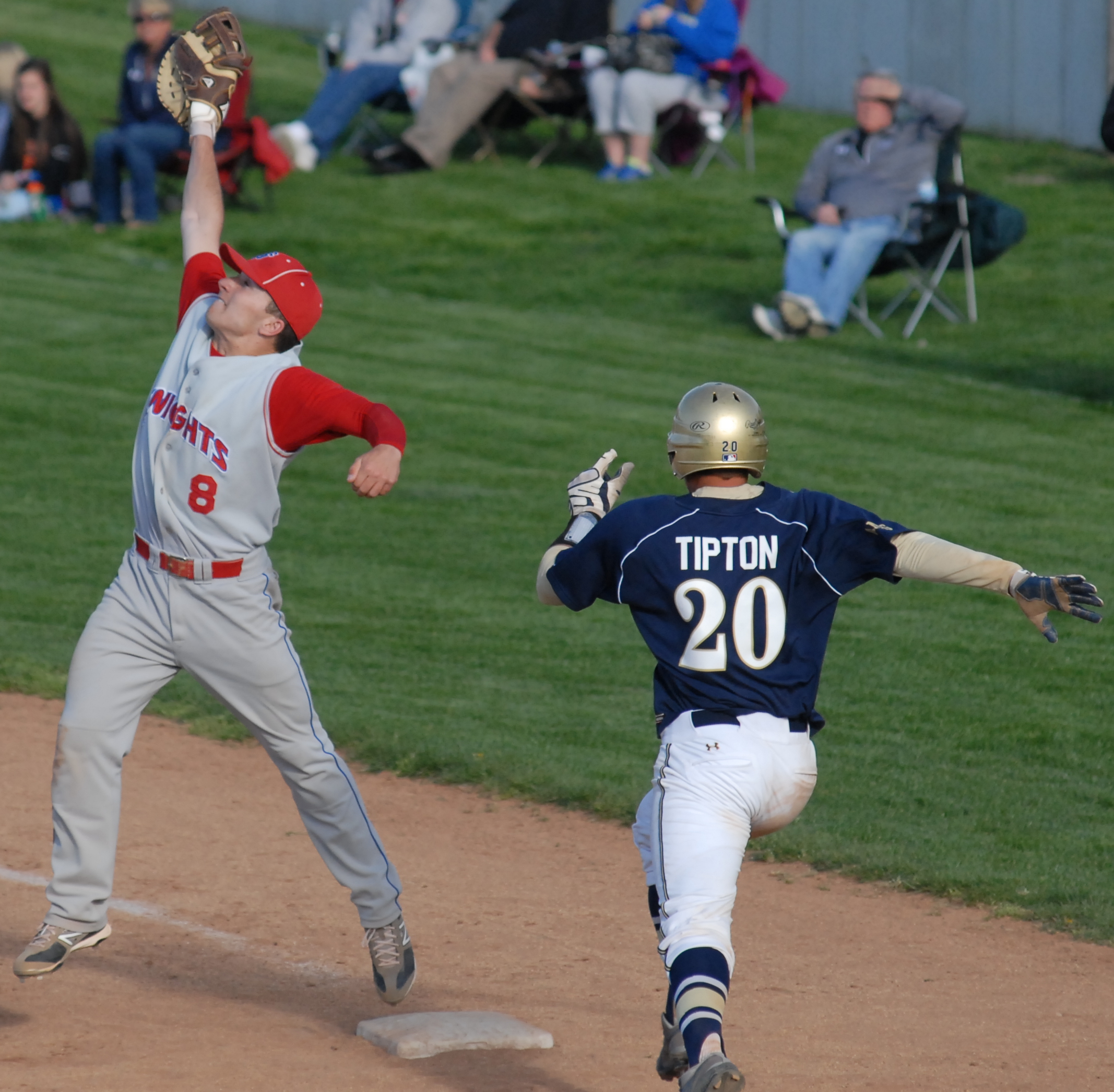 Matt Zmuda reaching up to snag the throw and get down on 1st base for an out on U of Toledo recruit Corey Tipton